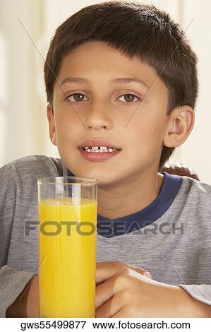 Portrait of a boy in front of a glass of juice View Large Photo Image Stock Photo - Portrait of a boy in front of a glass of juice. Fotosearch