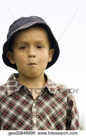 Stock Photo - Portrait of a boy looking serious. Fotosearch