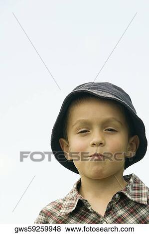 Stock Photo - Portrait of a boy making a face. Fotosearch