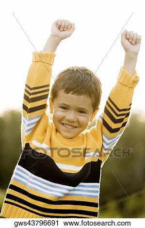 Portrait of a boy with his arms raised View Large Photo Image Stock Image - Portrait of a boy with his arms raised. Fotosearch