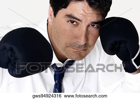 Portrait of a businessman wearing boxing gloves View Large Photo Image Stock Photograph - Portrait of a businessman wearing boxing gloves. Fotosearch