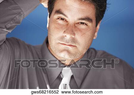 Portrait of a businessman with his hand in his hair View Large Photo Image Stock Image - Portrait of a businessman with his hand in his hair. Fotosearch
