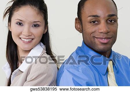 Portrait of a businesswoman and a businessman back to back View Large Photo Image Stock Photography - Portrait of a businesswoman and a businessman back to back. Fotosearch