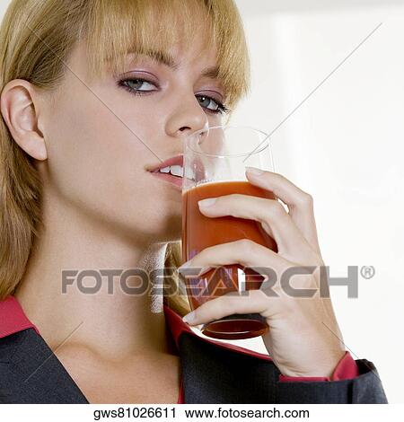 Portrait of a businesswoman holding a glass of juice View Large Photo Image Stock Image - Portrait of a businesswoman holding a glass of juice. Fotosearch