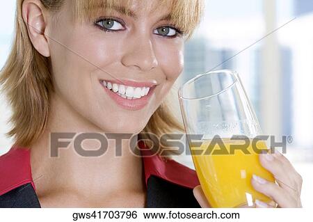Portrait of a businesswoman holding a glass of juice View Large Photo Image Stock Photograph - Portrait of a businesswoman holding a glass of juice. Fotosearch