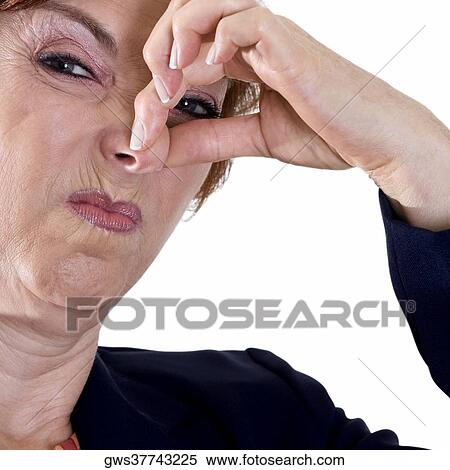 Portrait of a businesswoman holding her nose View Large Photo Image Stock Photography - Portrait of a businesswoman holding her nose. Fotosearch