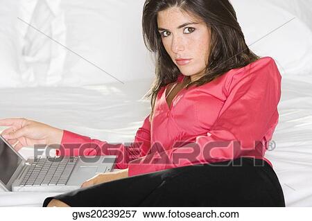 Portrait of a businesswoman in front of a laptop View Large Photo Image Stock Photo - Portrait of a businesswoman in front of a laptop. Fotosearch