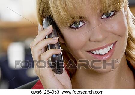 Stock Image - Portrait of a businesswoman talking on a mobile phone. Fotosearch