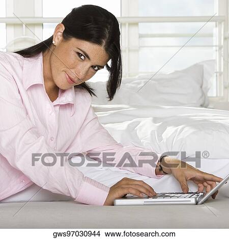 Portrait of a businesswoman using a laptop View Large Photo Image Picture - Portrait of a businesswoman using a laptop. Fotosearch