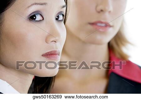 Portrait of a businesswoman with another businesswoman behind her View Large Photo Image Stock Photo - Portrait of a businesswoman with another businesswoman behind her. Fotosearch