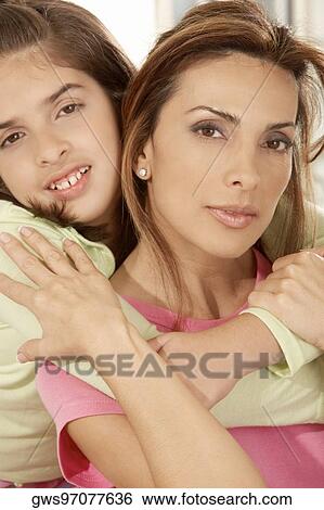 Portrait of a daughter hugging her mother from behind View Large Photo Image Stock Photograph - Portrait of a daughter hugging her mother from behind. Fotosearch