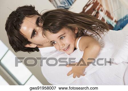 Portrait of a father hugging his daughter View Large Photo Image Stock Photo - Portrait of a father hugging his daughter. Fotosearch