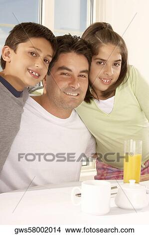 Portrait of a father with his son and his daughter smiling View Large Photo Image Picture - Portrait of a father with his son and his daughter smiling. Fotosearch