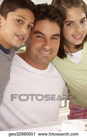 Portrait of a father with his son and his daughter smiling View Large Photo Image Stock Image - Portrait of a father with his son and his daughter smiling. Fotosearch