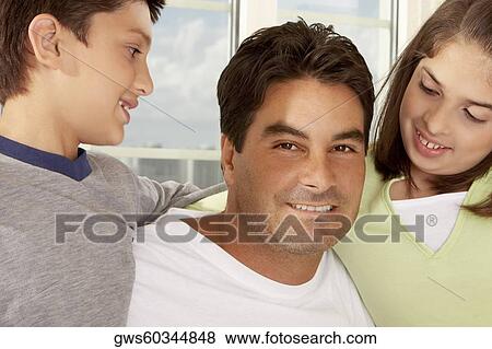 Portrait of a father with his son and his daughter smiling View Large Photo Image Stock Photo - Portrait of a father with his son and his daughter smiling. Fotosearch