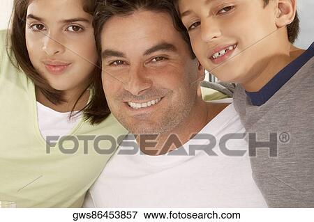 Portrait of a father with his son and his daughter smiling View Large Photo Image Stock Photo - Portrait of a father with his son and his daughter smiling. Fotosearch