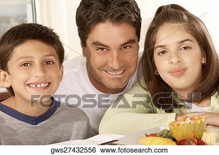 Portrait of a father with his son and his daughter smiling View Large Photo Image Stock Photograph - Portrait of a father with his son and his daughter smiling. Fotosearch