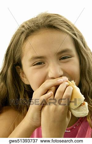 Portrait of a girl eating a hot dog View Large Photo Image Stock Photo - Portrait of a girl eating a hot dog. Fotosearch