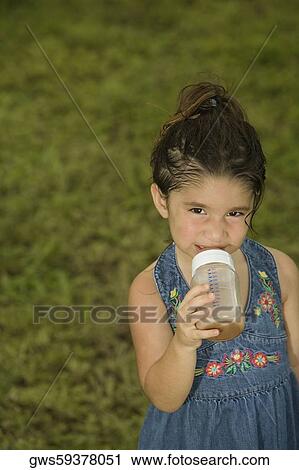 Portrait of a girl holding a baby bottle View Large Photo Image Stock Image - Portrait of a girl holding a baby bottle. Fotosearch