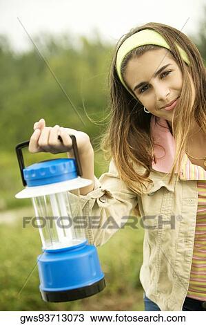 Stock Image - Portrait of a girl holding a lantern. Fotosearch