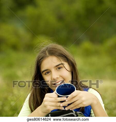 Portrait of a girl holding a mug View Large Photo Image Picture - Portrait of a girl holding a mug. Fotosearch