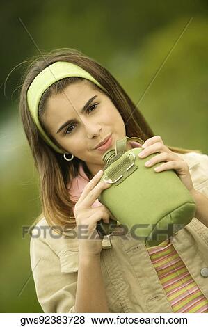 Portrait of a girl holding a water bottle View Large Photo Image Stock Photo - Portrait of a girl holding a water bottle. Fotosearch