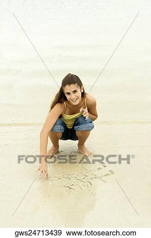 Portrait of a girl playing tic-tac-toe on the beach View Large Photo Image Stock Photo - Portrait of a girl playing tic-tac-toe on the beach. Fotosearch