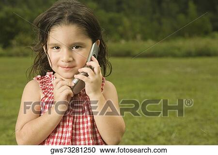 Stock Image - Portrait of a girl talking on a mobile phone. Fotosearch