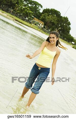 Portrait of a girl wading in water on the beach View Large Photo Image Stock Photo - Portrait of a girl wading in water on the beach. Fotosearch