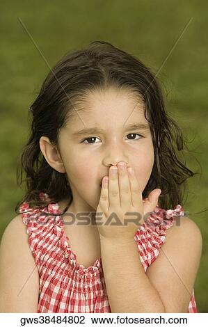 Portrait of a girl with her hand over her mouth View Large Photo Image Stock Image - Portrait of a girl with her hand over her mouth. Fotosearch