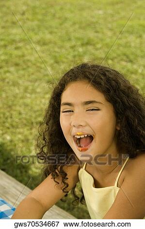 Portrait of a girl with her mouth open View Large Photo Image Stock Photo - Portrait of a girl with her mouth open. Fotosearch