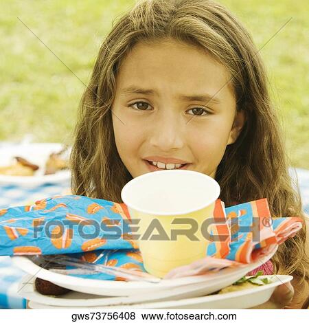 Portrait of a girl with plates and a disposable cup View Large Photo Image Stock Photo - Portrait of a girl with plates and a disposable cup. Fotosearch