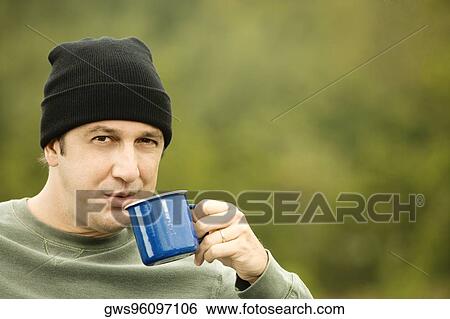 Portrait of a mature man drinking from a mug View Large Photo Image Stock Photograph - Portrait of a mature man drinking from a mug. Fotosearch