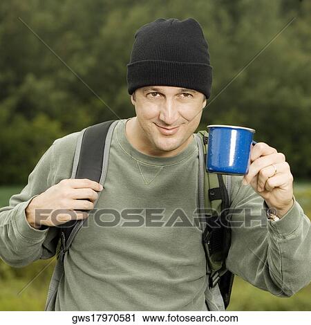 Portrait of a mature man holding a mug View Large Photo Image Stock Image - Portrait of a mature man holding a mug. Fotosearch