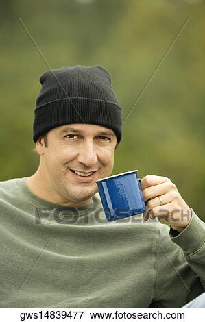 Portrait of a mature man holding a mug View Large Photo Image Stock Photo - Portrait of a mature man holding a mug. Fotosearch