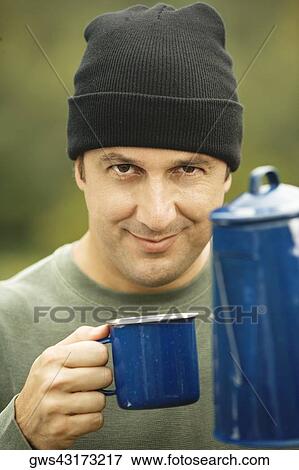 Portrait of a mature man holding a mug View Large Photo Image Stock Photo - Portrait of a mature man holding a mug. Fotosearch