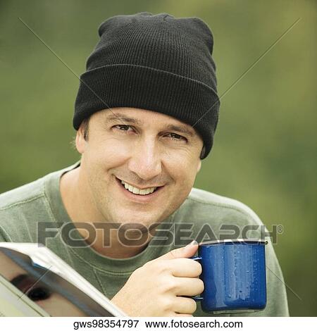 Stock Photo - Portrait of a mature man holding a mug. Fotosearch