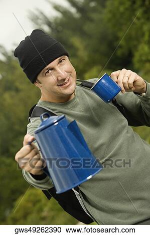 Portrait of a mature man holding a kettle and a mug View Large Photo Image Stock Image - Portrait of a mature man holding a kettle and a mug. Fotosearch