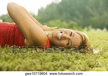 Portrait of a mature woman lying on the lawn View Large Photo Image Picture - Portrait of a mature woman lying on the lawn. Fotosearch