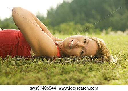 Portrait of a mature woman lying on the grass View Large Photo Image Picture - Portrait of a mature woman lying on the grass. Fotosearch