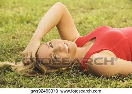 Portrait of a mature woman lying on the lawn View Large Photo Image Stock Photo - Portrait of a mature woman lying on the lawn. Fotosearch