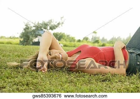 Portrait of a mature woman lying on the lawn View Large Photo Image Stock Photograph - Portrait of a mature woman lying on the lawn. Fotosearch