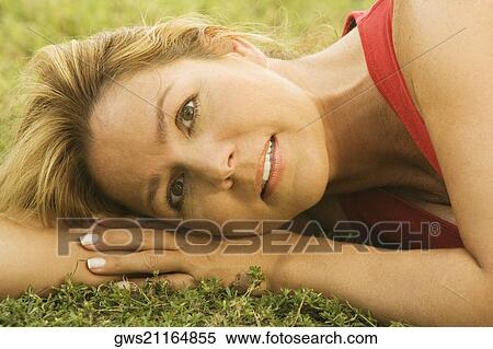 Portrait of a mature woman lying on the lawn View Large Photo Image Stock Photography - Portrait of a mature woman lying on the lawn. Fotosearch