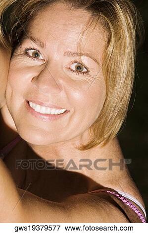 Portrait of a mature woman smiling View Large Photo Image Stock Photo - Portrait of a mature woman smiling. Fotosearch