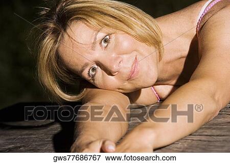 Portrait of a mature woman smiling View Large Photo Image Stock Photo - Portrait of a mature woman smiling. Fotosearch