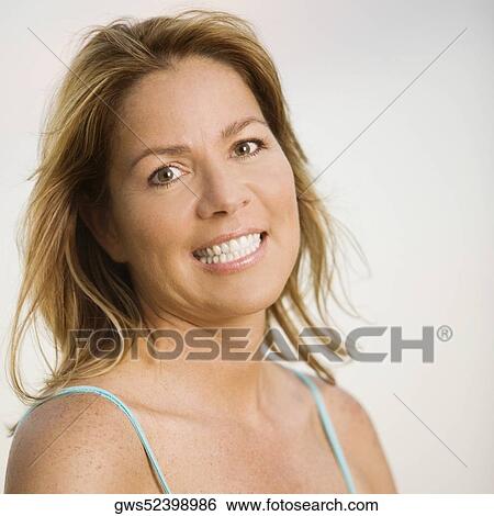 Portrait of a mature woman smiling View Large Photo Image Stock Photograph - Portrait of a mature woman smiling. Fotosearch