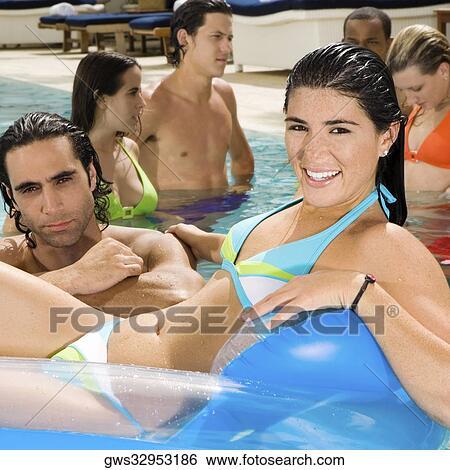 Portrait of a mid adult man and a young woman in a swimming pool View Large Photo Image Stock Photograph - Portrait of a mid adult man and a young woman in a swimming pool. Fotosearch