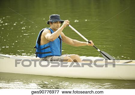 Portrait of a mid adult man boating in a river View Large Photo Image Stock Photo - Portrait of a mid adult man boating in a river. Fotosearch