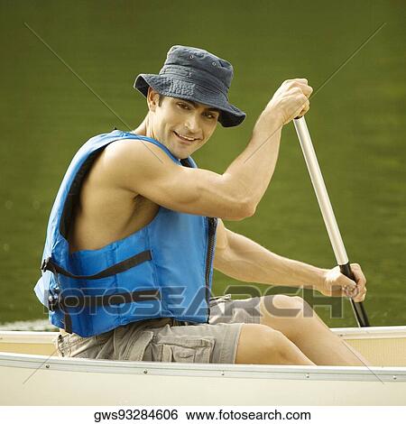 Portrait of a mid adult man boating in a river View Large Photo Image Stock Photograph - Portrait of a mid adult man boating in a river. Fotosearch