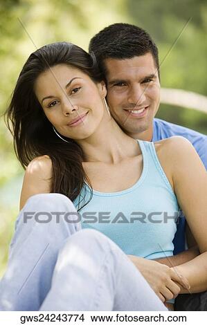 Portrait of a mid adult man embracing a young woman from behind View Large Photo Image Picture - Portrait of a mid adult man embracing a young woman from behind. Fotosearch